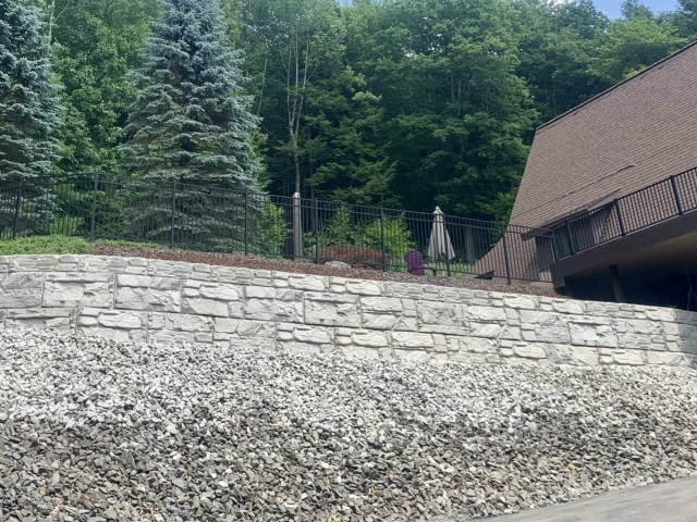 MagnumStone retaining wall replaces old failing wall for outdoor deck.